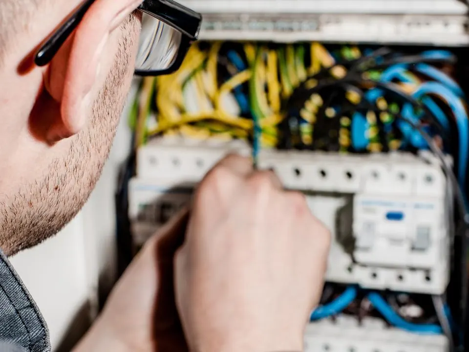 Electrician connecting wires inside a home electrical panel